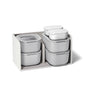 The Caraway Mini Food Storage Set W/ Storage includes six non-toxic containers with lids, organized in a light gray textured box with three compartments—ideal for easy kitchen storage and organization.