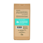 A tan Dr. Squatch Body Wash bottle is shown from the back, featuring product info, ingredients, a barcode, and branding in black and teal text. The packaging highlights that this natural body wash uses recycled materials.