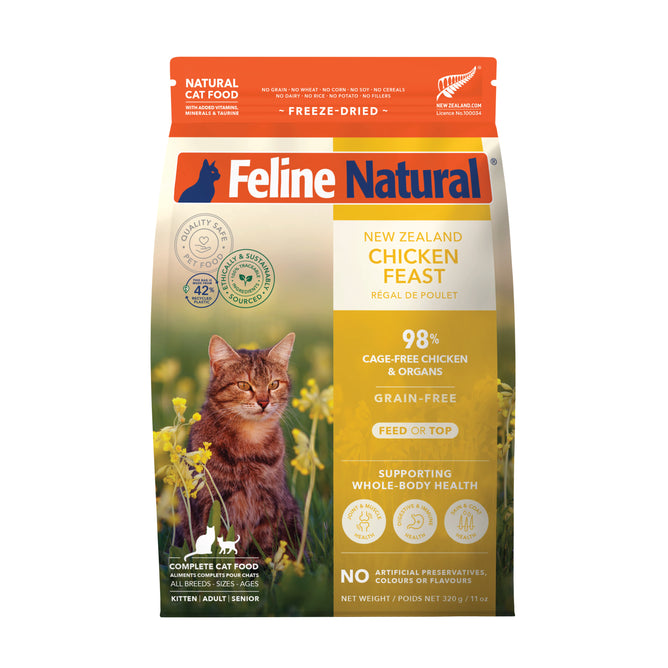 The Feline Natural Grain-Free Freeze-Dried Cat Food bag features a cat in grass, highlighting its New Zealand Chicken Feast made with natural ingredients, cage-free chicken, and no artificial preservatives. Suitable for all life stages.