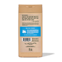 A tan Dr. Squatch Body Wash bottle is shown from the back, with a label featuring usage notes, ingredients, product details, and a blue real soap formula section. The men's body wash bottle is made using recycled materials.