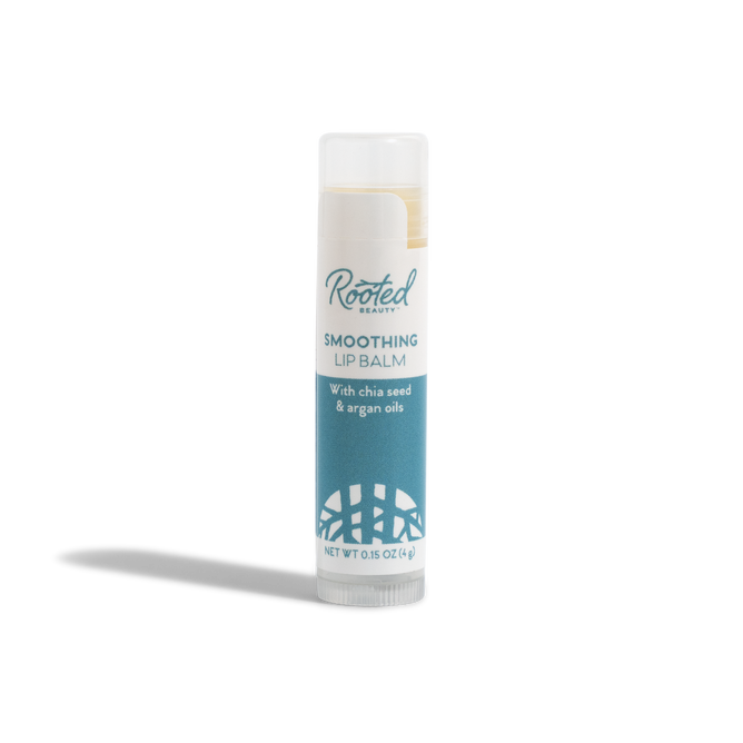 A tube of Rooted Beauty Smoothing Lip Balm - 100% Organic - Mint Flavor, with a white cap and blue label, stands upright on a white background.