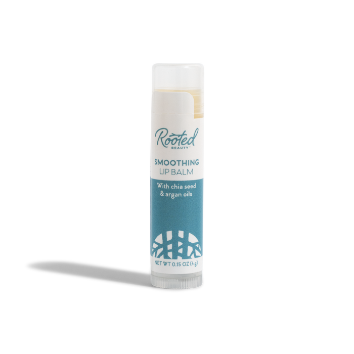 A tube of Rooted Beauty Smoothing Lip Balm - 100% Organic - Mint Flavor, with a white cap and blue label, stands upright on a white background.
