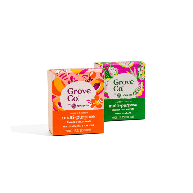 Two Grove Co. Multi-Purpose Cleaner Concentrate Set - Summer Collection boxes—one Wildflowers & Apricot, one Papaya & Sage—stand upright on a white background. Both Limited Edition, they use bio-based ingredients for a refillable cleaning system.