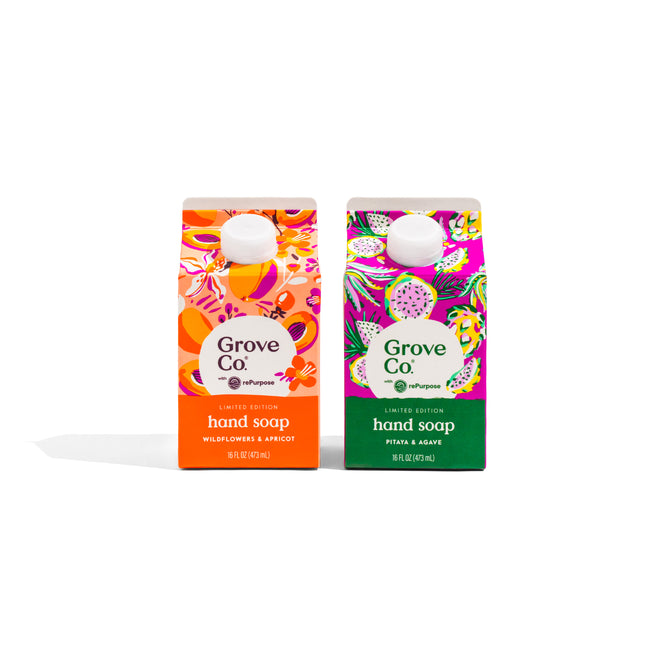 Two Grove Co. Hand Soap Set - Summer Collection cartons stand side by side with tropical designs: orange with wildflowers and apricot, green/purple with feta and agave. Both feature moisturizing aloe vera and have white caps.