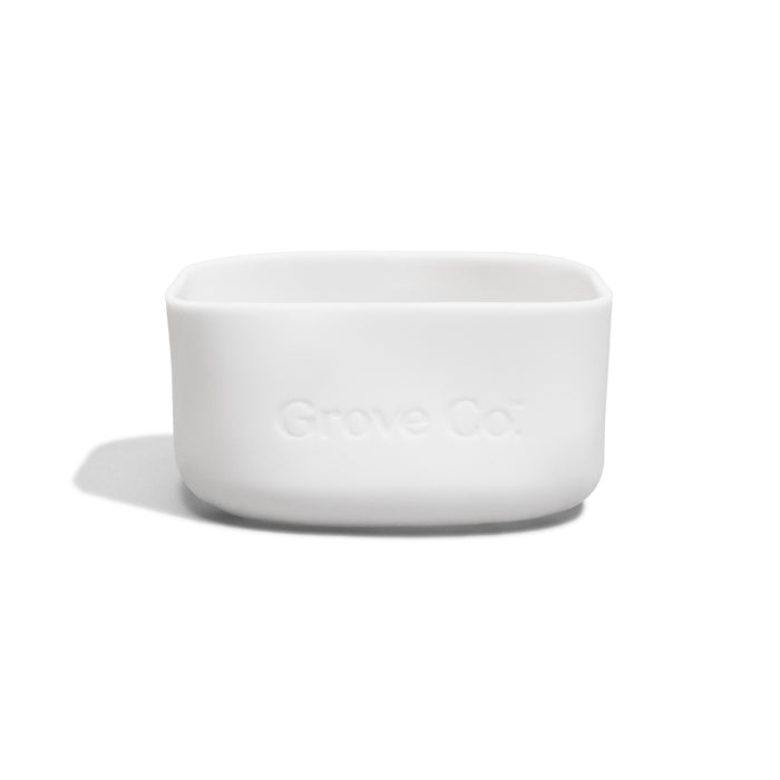 A small, white, rectangular Grove Co. Silicone Sleeve - Glass Foaming Hand Soap Dispenser with rounded edges, featuring a non-slip silicone sleeve and Grove Co. embossed on the front, displayed against a plain white background.