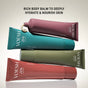 Four vibrant tubes of VOESH Body Balm are stacked diagonally on a light background. Text above says: Rich body balm with mango seed butter to hydrate and nourish skin deeply.