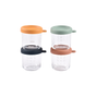 Four BEABA Glass Baby Food Jars with orange, green, black, and brown silicone lids are stacked in pairs. Each jar features measurement markings and a small lid handle—ideal for homemade baby food storage. White background.