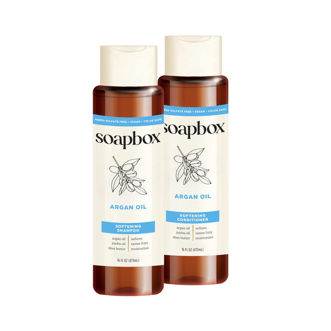 Two 16 fl oz bottles of Soapbox Argan Oil Control & Soften Shampoo and Conditioner Set, each with brown caps, botanical labels, and Certified B Corporation assurance.
