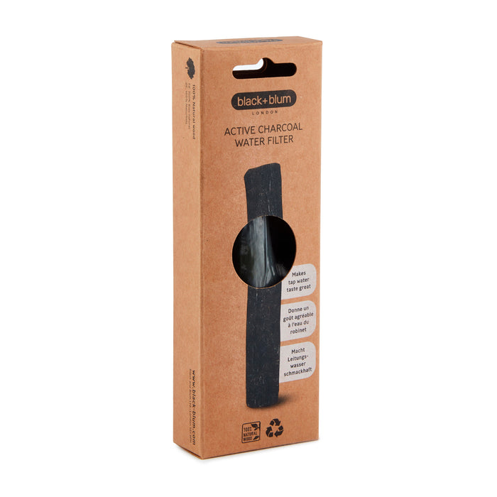 A rectangular brown box with a cutout showcases the Black + Blum Active Charcoal Water Filter inside, highlighting its use for water filtration, recyclability, and option for charcoal filter refills.