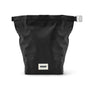 The Black + Blum Lunch Bag is a black, rectangular fabric roll-top with a silver buckle and a small front label, shown standing upright against a plain white background.