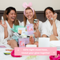 Three women in white robes laugh on a bed, holding FaceTory Girls’ Night Glow Face Sheet Masks and other hydrating skincare products. Text overlay: "Girls' night must-have—reveal your glow together.
