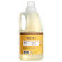 A clear bottle of Mrs. Meyer's Baby Laundry Detergent with a yellow label and white cap, featuring product details and illustrations on the packaging, is crafted with naturally derived ingredients—just like other Mrs. Meyer’s products.