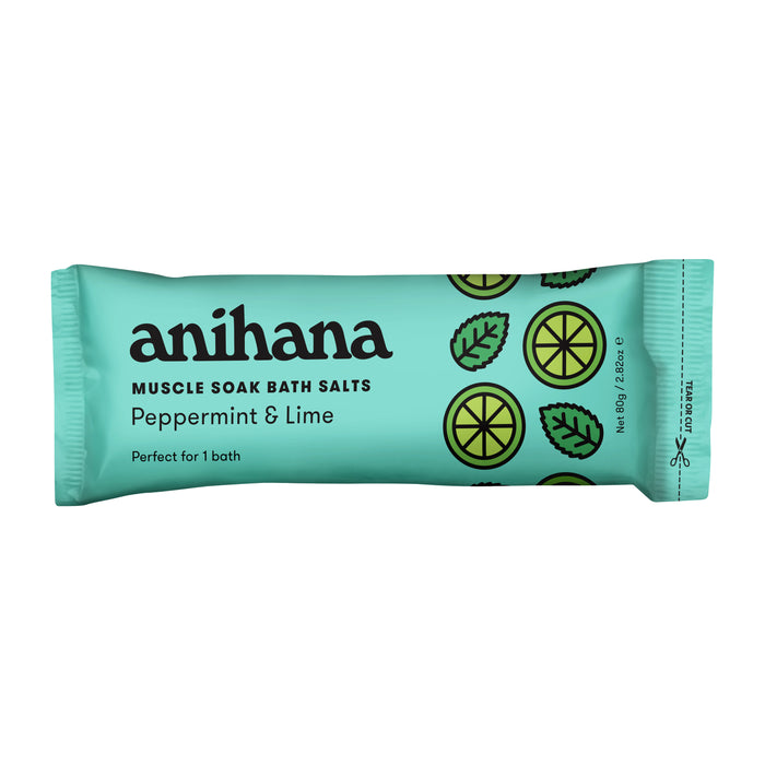 A teal packet of anihana Muscle Soak Bath Salts with peppermint and lime, black text, and lime and mint leaf illustrations on the right side. Net weight 100g.