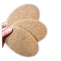 A hand holds three Scrub Be Love Coconut Coir Dish Scrubs, made from natural brown coconut fibers, fanned out against a white background.