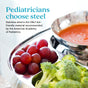 A stainless steel Ahimsa Smart Snacking Bowl holds grapes and broccoli beside a bowl of tomato soup. Text reads: Pediatricians choose steel. Ahimsa’s all-steel dishes are the ONLY plastic-free kids’ dishes recommended by the AAP.