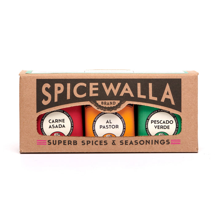 The Spicewalla Taco 3 Pack Collection includes Carne Asada, Al Pastor, and Pescado Verde seasonings in vibrant tins, delivering authentic taquería flavors for your Taco Tuesday. Comes in a brown box with colorful accents.