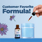 A hand dispenses MaryRuth's Organic Lymphatic Support Herbal Blend Liquid Drops into a glass of water beside the product bottle on a blue background with purple flowers and the text Customer Favorite Formula!.