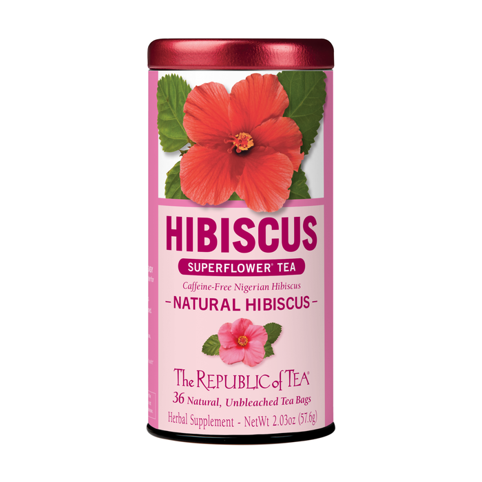 A cylindrical tin of “Natural Hibiscus Tea” by The Republic of Tea features a pink label with tropical herbal tea from Nigerian hibiscus, containing 36 natural unbleached tea bags; this caffeine-free blend is perfect for any occasion.