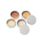 The Complete Minibar Set by Ember Wellness features four round metal tins, each with a unique solid moisturizing bar and EMBER engraved on top. Two tins are closed, while the other two display their lids beside the bars.