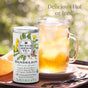 A canister of The Republic of Tea’s Organic Dandelion SuperHerb Tea is shown beside a mason jar of iced tea with lemon outdoors. Text: Enjoy this digestive aid hot or iced as a refreshing coffee alternative under the sun.