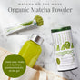 A canister and packet of The Republic of Tea Organic Matcha Single Sips, a green bottled drink, and a beige tote bag sit on a light surface. A green circle reads: Simply pour, shake, sip—enjoy premium matcha with monk fruit anywhere!.