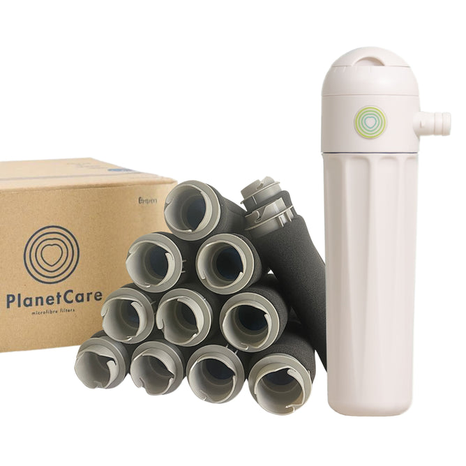 The PlanetCare 2.0 Microfiber Filter Kit, a white plastic washing machine attachment by PlanetCare, sits beside grey pipes and is designed to help remove microplastics from laundry water.