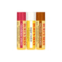 Three Burt’s Bees Lip Balm Cozy Season tubes stand side by side in cranberry spritz, sugar cookie, and salted caramel flavors, each featuring distinct colored caps and labels.