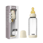 A BIBS Glass Baby Bottle with Natural Rubber Nipple Complete Set (0+ Months) is placed in front of its packaging, with the beige cap and bottle displayed together; the box highlights key product details.