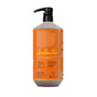 A large orange pump bottle of Alaffia EveryDay Shea Body Wash features white and yellow text displaying ingredients and product details. Icons highlight that it is cruelty-free, synthetic dye-free, and recyclable. Infused with fair trade shea butter, this unscented body wash is gentle enough for sensitive skin. The brand name and label are partially visible.