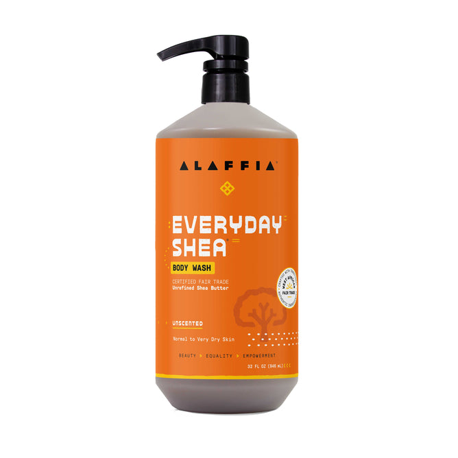 A large pump bottle of Alaffia EveryDay Shea Body Wash with an orange label, highlighting its fair trade shea butter and suitability for normal to very dry or sensitive skin.