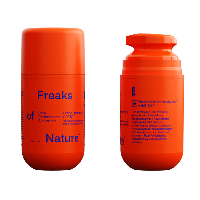 Two bright orange bottles of Peak Performance SPF50 Sunscreen by Freaks of Nature stand out with blue text. The left bottle has a cap, and the right features a pump dispenser, both enhanced with non-nano zinc for optimal skin protection.