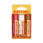 Burt’s Bees Lip Balm Cozy Season trio includes cranberry spritz, sugar cookie, and salted caramel flavors. The red, brown, and yellow packaging displays the Burt’s Bees logo at the top.