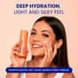 A smiling woman applies FaceTory Glow Serum Face Milk to her cheek, holding its orange bottle. The text reads: Deep hydration, glass-skin finish. Fast-absorbing, non-sticky—perfect under makeup for silky smooth skin.