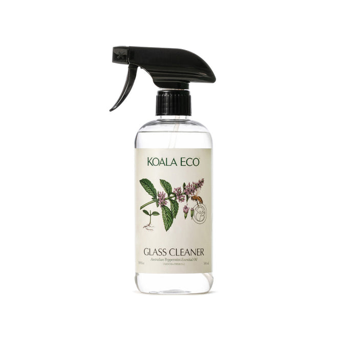 A clear spray bottle labeled Koala Eco Natural Glass Cleaner with a black trigger nozzle. The label displays botanical illustrations and highlights Australian peppermint essential oil for a smear-free shine on windows.