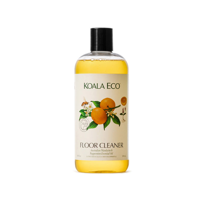 A clear plastic bottle of Koala Eco Natural Floor Cleaner with a black cap and a label featuring orange and green leaf illustrations, highlighting Australian Mandarin & Peppermint Essential Oil.