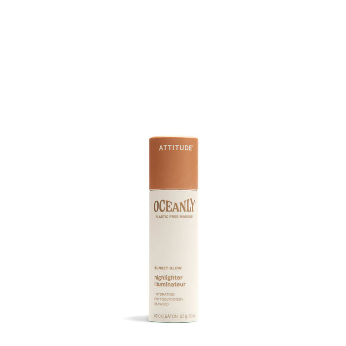 A cylindrical tube of Oceanly Highlighter by ATTITUDE features a tan cap, cream body, brown text, and showcases its plastic-free makeup with naturally sourced ingredients.
