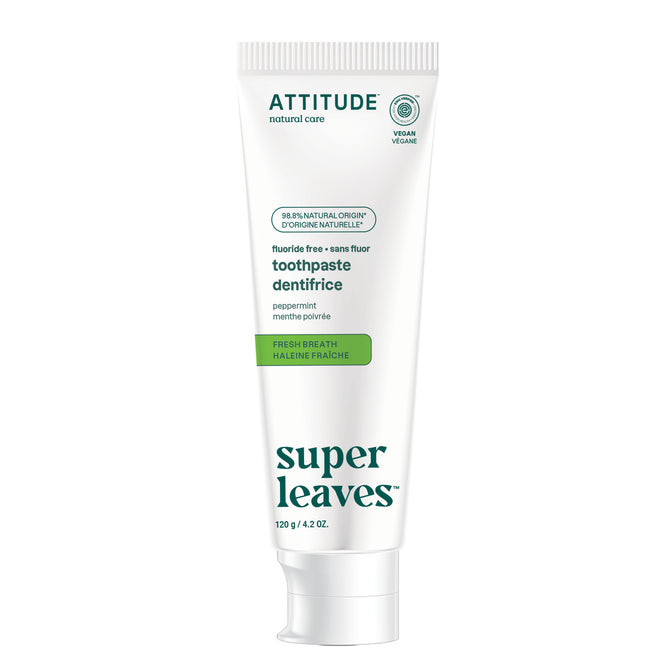 A white tube of ATTITUDE super leaves Fluoride-free Toothpaste - Fresh Breath, labeled vegan and peppermint flavor, with green accents. Made with 98.5% natural ingredients for fresh breath without fluoride.