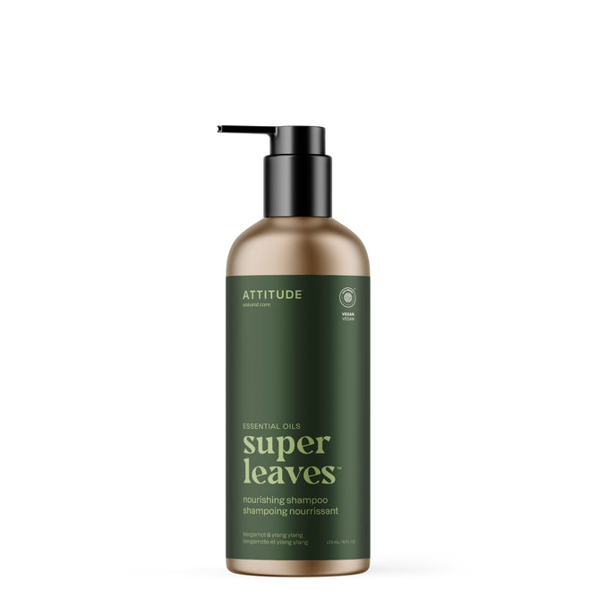 A pump bottle of ATTITUDE super leaves essential oils Shampoo Nourishing with a dark green label and gold cap is shown upright on a white background. Made with naturally sourced ingredients.