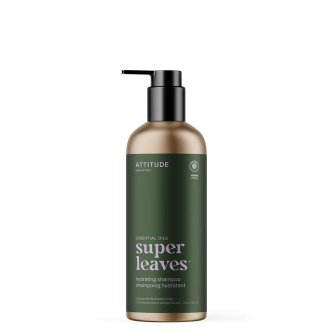 A bottle of ATTITUDE super leaves essential oils Shampoo Hydrating, with a black pump and dark green label featuring Peppermint & Sweet Orange, sits on a plain white background. This vegan shampoo contains essential oils.