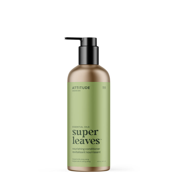 A green bottle of ATTITUDE super leaves essential oils Conditioner Nourishing with a black pump features Bergamot & Ylang-Ylang, naturally sourced ingredients, and is designed to strengthen and revive hair.