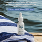A bottle of Three Ships Jelly Drops Kakadu Plum + Mushroom Hyaluronic Acid Serum sits on a striped towel by the water. Text promotes this hydration serum with Tremella Mushroom, clinically and dermatologist tested for glow and elasticity.