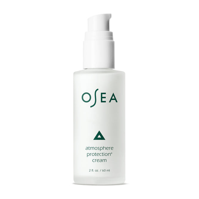 A white pump bottle of OSEA Atmosphere Protection® Cream, a seaweed moisturizer with green text and a small green triangle above the name. This 2 fl. oz. (60 ml) bottle hydrates skin and offers anti-pollution benefits.