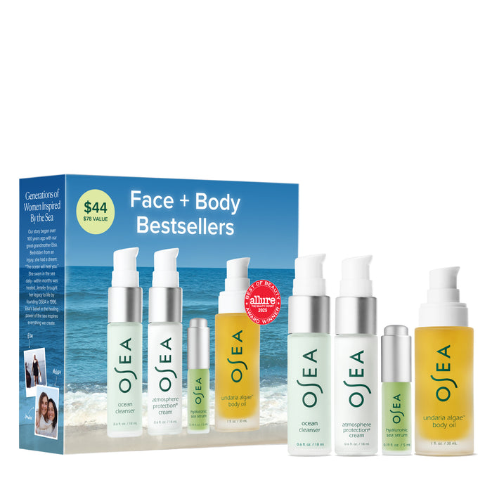 OSEA Face + Body Bestsellers, featuring cleansers, creams, and body oil, are displayed before a blue box with ocean scenery—an ideal upgrade for your skincare routine.