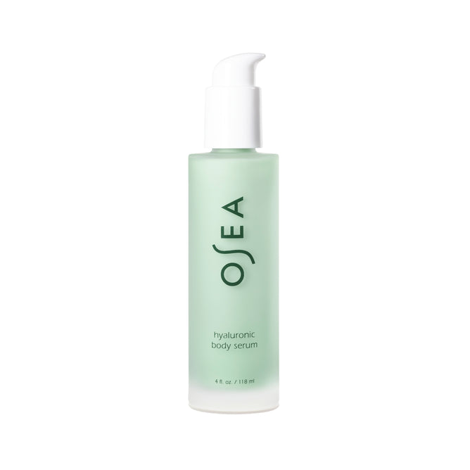 A 4 fl. oz. (118 ml) frosted green bottle of OSEA Hyaluronic Body Serum with a white pump stands upright on a white background. This ultra-hydrating serum with hyaluronic acid is ideal for sensitive skin.