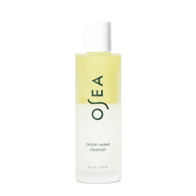 A clear 4 fl oz (118 mL) bottle of OSEA Ocean Wave Cleanser Bi-Phase Cleansing Oil and Makeup Remover features a white cap, green label text, and a striking dual-layer formula with golden liquid on top and clear liquid below—perfect for your double cleanse routine.
