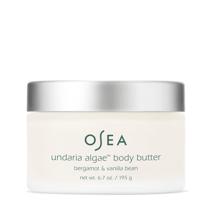 A jar of OSEA Undaria Algae™ Body Butter Bergamot & Vanilla Bean with a silver lid. The creamy white formula (6.7 oz) delivers firming hydration for soft, supple skin.