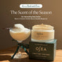 A jar of OSEA Undaria Algae™ Body Butter Bergamot & Vanilla Bean sits on its box beside a creamy dessert in warm sunlight, highlighting the limited-edition, firming hydration scent: bergamot and vanilla bean.