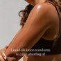 A person applies lotion to their shoulder, revealing radiant skin. Text reads: Golden Glow Body Duo Gift Set by OSEA delivers fast-absorbing seaweed body oil for glowing hydration.