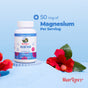 A bottle of MaryRuth's Magnesium Calm Gummies rests on blue sand with hibiscus flowers, showcasing "50 mg of Magnesium Per Serving" above. Ideal for promoting bone health and muscle relaxation, the scene is framed by a calming gradient blue backdrop.