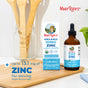 A bottle and box of MaryRuth’s Liquid Ionic Zinc are on a kitchen counter with wooden utensils behind them. Text highlights up to 13.1 mg zinc per serving and the benefits of this liquid zinc supplement for immune support.